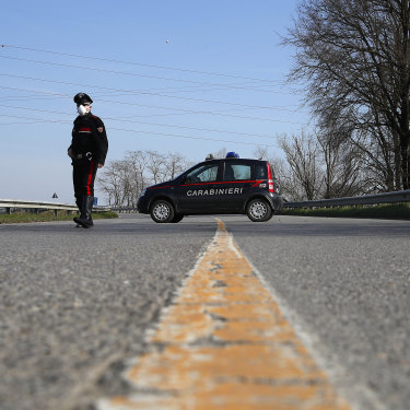 A sole Carabinieri officer at a checkpoint near Codogno, one of dozens of similar roadblocks set up in northern Italy. 