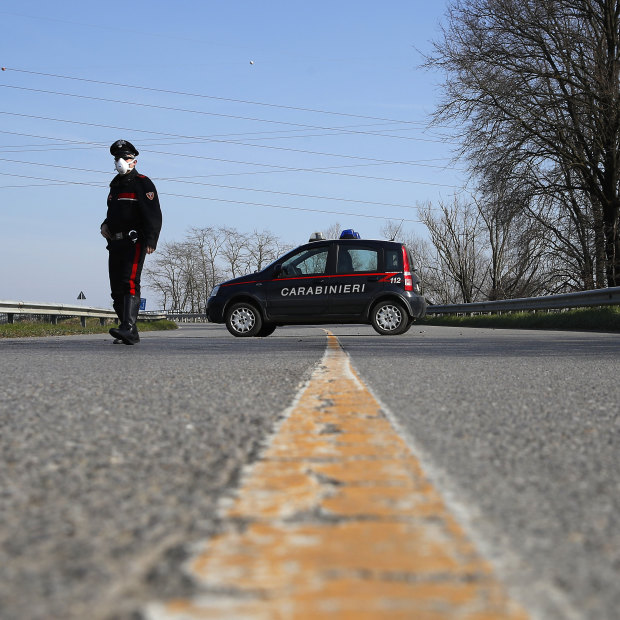 A sole Carabinieri officer at a checkpoint near Codogno, one of dozens of similar roadblocks set up in northern Italy. 