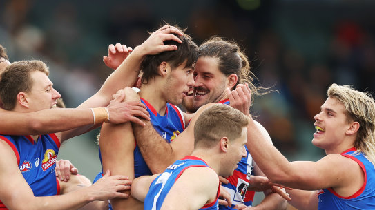 Sam Darcy celebrates a goal with  Bulldogs teammates.