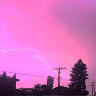 Pink sky above Melbourne as electrical storm lights up the city