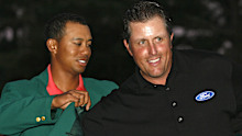 Phil Mickelson receives his green jacket from Tiger Woods after winning the 2006 Masters at the Augusta National Golf Club in Augusta, Georgia on April 9, 2006. (Photo by Hunter Martin/WireImage)