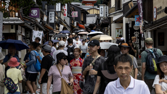 The ascent of the masses, as visitors walk the sloping streets to the Kiyomizu-dera Temple.