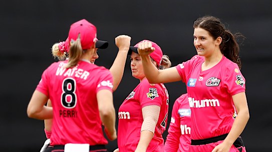 Stella Campbell, right, enjoys a wicket with the Sixers.
