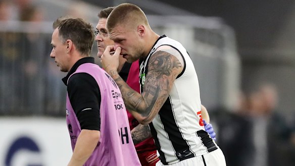 Collingwood Jordan De Goey is helped off the ground during the clash with the West Coast Eagles at Optus Stadium. He will miss the Anzac Day blockbuster with Essendon.