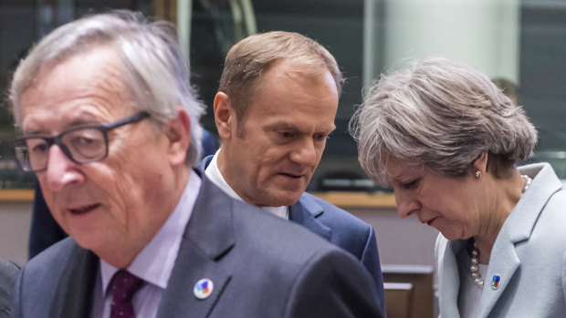 British Prime Minister Theresa May, right, speaks with European Council President Donald Tusk, second left, as European Commission President Jean-Claude Juncker looks on during a 2017 meeting in Brussels. 