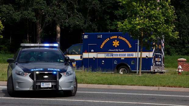 An ambulance turns on Nimmo Parkway following a shooting at the Virginia Beach Municipal Centre on Friday.