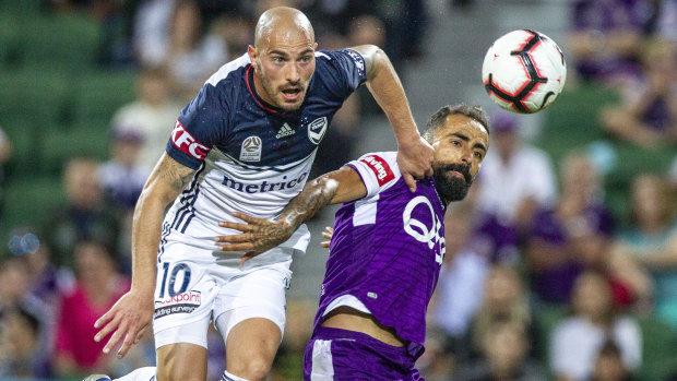 High intensity: Victory's James Troisi clears under pressure from Glory's Diego Castro.