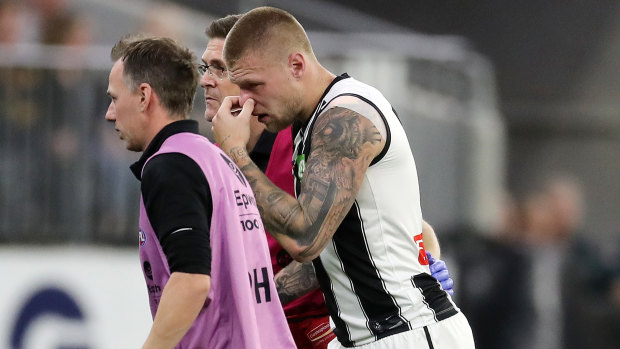 Collingwood Jordan De Goey is helped off the ground during the clash with the West Coast Eagles at Optus Stadium. He will miss the Anzac Day blockbuster with Essendon.