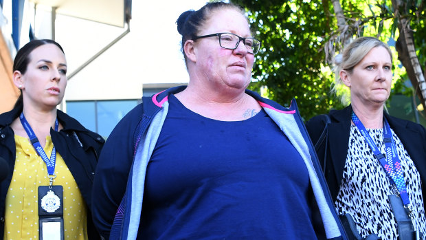 Shannon White (centre) is taken from the Morningside police station after she was arrested.