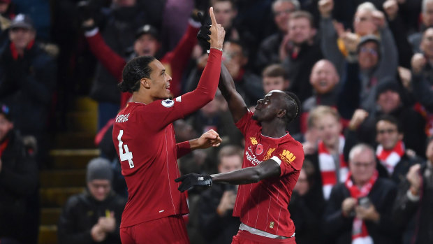 Sadio Mane (right) celebrates Liverpool's third goal on an emphatic night for the Reds.