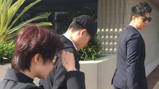 The mother (left) and brother (centre) of Yu Zhang leave the Southport Magistrates Court on Monday.