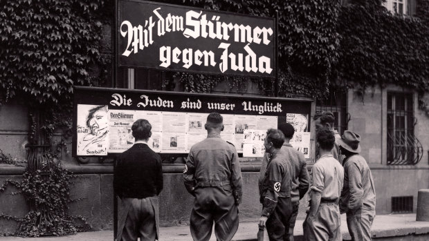 The anti-Semitic Nazi newspaper Der Sturmer is put up in the street of Worms, Germany, under the headline "The Jews are our Misfortune".
