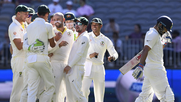 Prize wicket: Lyon enjoys the scalp of Indian captain Virat Kohli in the second Test in Perth.