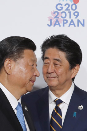 Japanese Prime Minister Shinzo Abe, right, has spent much of his time as leader trying to repair his country's relationship with China. He's pictured here with Chinese President Xi Jinping at the G-20 meeting in Osaka earlier this year. 