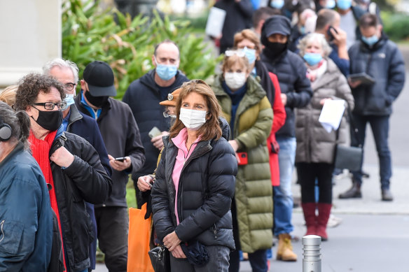 People queue to receive their COVID-19 vaccinations at Melbourne’s Royal Exhibition Building.