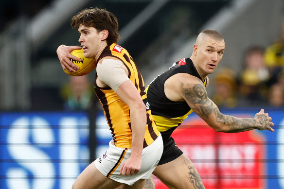 Will Day, of the Hawks, evades an attempted tackle by Richmond’s Dustin Martin earlier this season.