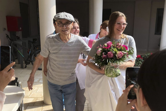 Resident Mr Chatal smiles during a fake wedding with a nurse at the care home in Lyon.