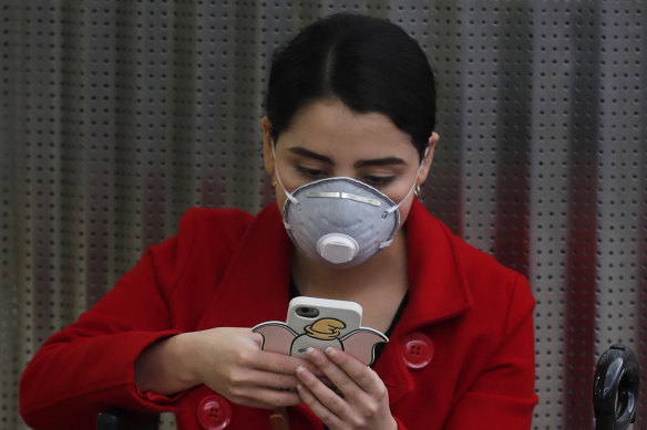 A woman wears a protective mask as a precaution against the spread of the new coronavirus at the airport in Mexico City on Friday.