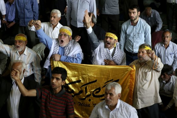 Iranians hold a flag that reads Death to America during Friday prayer at Tehran University in 2016.