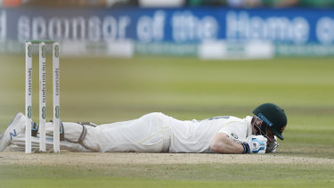 Steve Smith lies on the ground after being hit on the head by a ball bowled by England's Jofra Archer. 