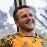 Dylan Pietsch posing in Wallabies kit on a Melbourne tram in 2023, while in the Australian squad.