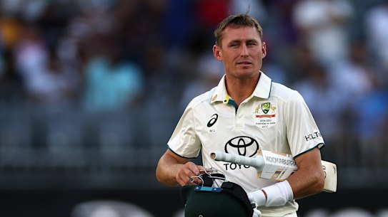 Marnus Labuschagne departs Perth Stadium on Sunday, taking a review with him after being dismissed lbw.