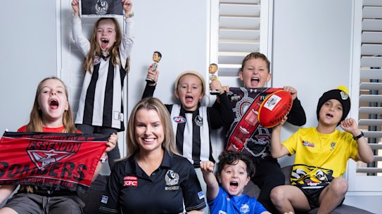 Casey Nunn shares the couch with young footy fans. (L-R) Charlotte 7, Chloe 6, Molly 6, Andre 4, Lachlan 9, and Levi 8.