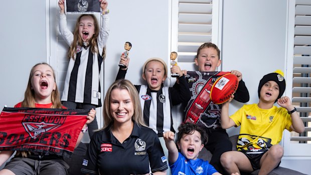 Casey Nunn shares the couch with young footy fans. (L-R) Charlotte 7, Chloe 6, Molly 6, Andre 4, Lachlan 9, and Levi 8.