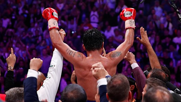 Manny Pacquiao celebrates his win over Keith Thurman by split decision in a welterweight title fight. 