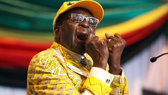 Robert Mugabe, then-President, clenches his fists as he delivers his speech at his party's annual conference in 2012.