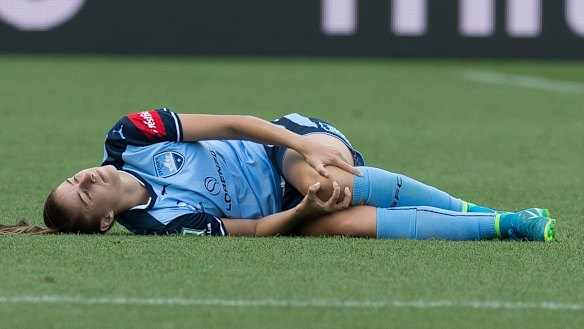 Excruciating: Amy Harrison injures her left knee playing for Sydney FC.