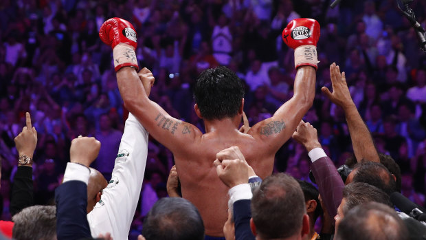 Manny Pacquiao celebrates his win over Keith Thurman by split decision in a welterweight title fight. 
