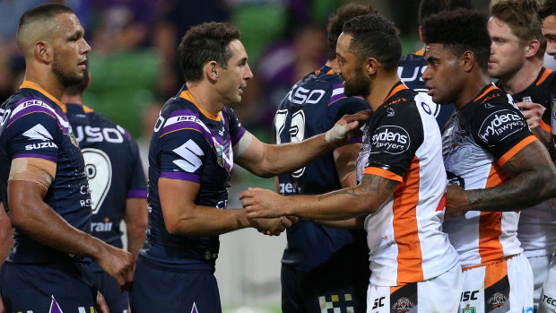Unexpected victory: Billy Slater of the Storm shakes hands with Benji Marshall of the Tigers.