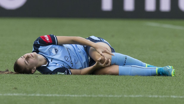 Excruciating: Amy Harrison injures her left knee playing for Sydney FC.