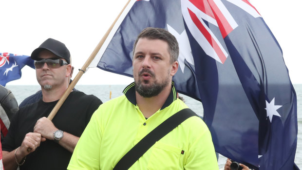 Neil Erikson, in yellow shirt, at a protest in Melbourne.
