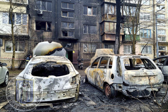 Cars are destroyed after cruise and ballistic missiles were shot down over Kyiv on Thursday.