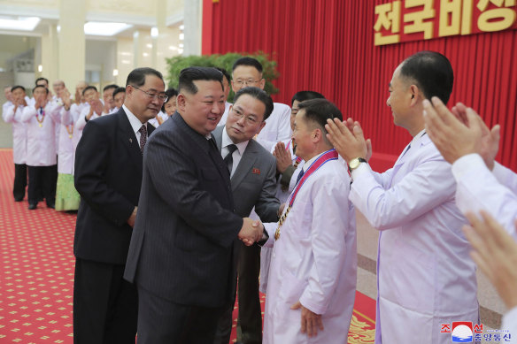 North Korean leader Kim Jong-un shakes hands with a health official in Pyongyang, North Korea.