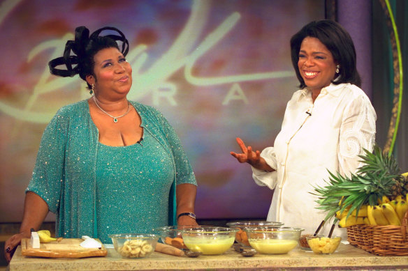 Oprah in 1999, cooking with Aretha Franklin.