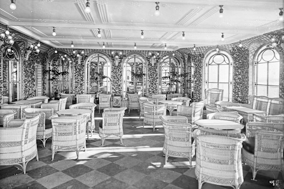 A photo by shipmaker Harland & Wolff's official photographer Robert John Welch of the cafe on-board the RMS Olympic, taken while the ship was in the fitting yard. Johannes Vogelin made coffee on the Olympic and its sister ship the Titanic. 