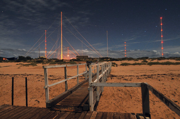 The Harold E. Holt Naval Communication Station’s transmission towers glow against the night sky.