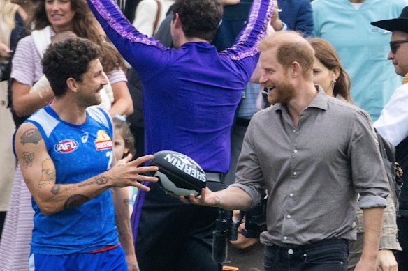 Tom Liberatore teaches Harry about Australian rules football.