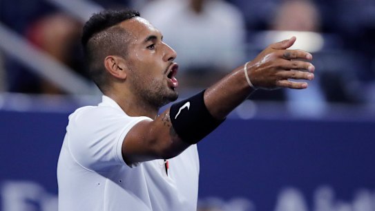 Nick Kyrgios points out distractions in the crowd during his match against Steve Johnson.