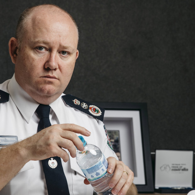 Shane Fitzsimmons in his office - with water bottle, a day when he's skipped lunch.