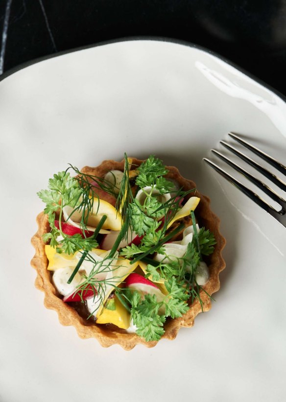 Seasonal vegetable tart with wattleseed curd.