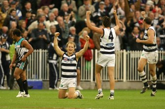 Geelong players celebrate victory after the final siren.