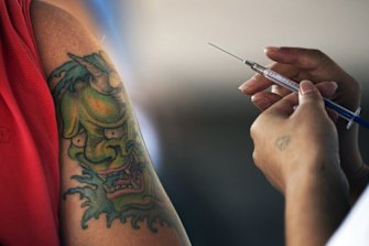 A health worker administers a jab of the AstraZeneca COVID-19 vaccine. 