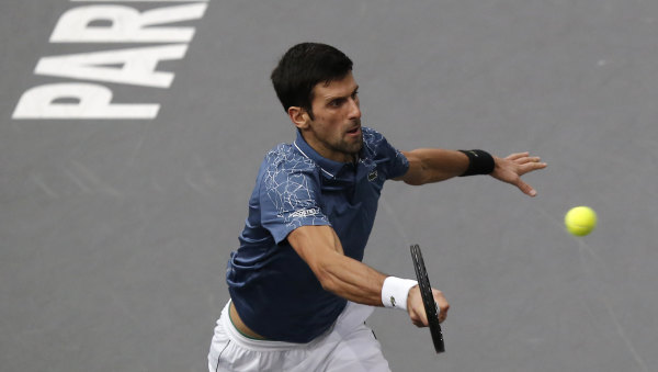 Novak Djokovic returns the ball to Karen Khachanov in Paris on Sunday.