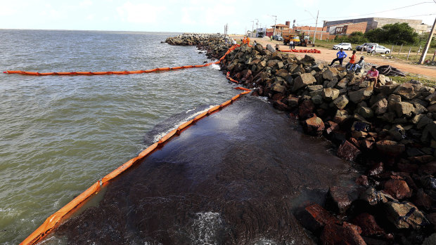 Rocks stained by an oil spill on Artistas Beach in Aracaju, Brazil. 