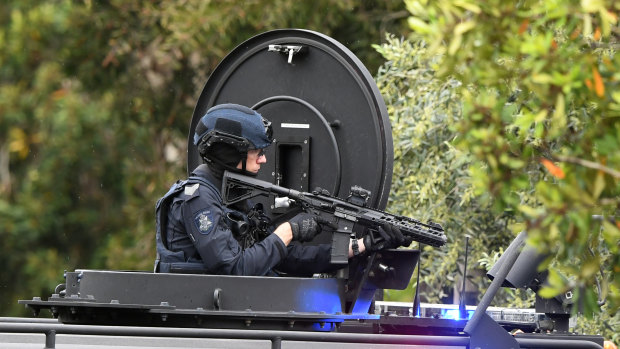 An armed officer is seen at the Westbury Street standoff.