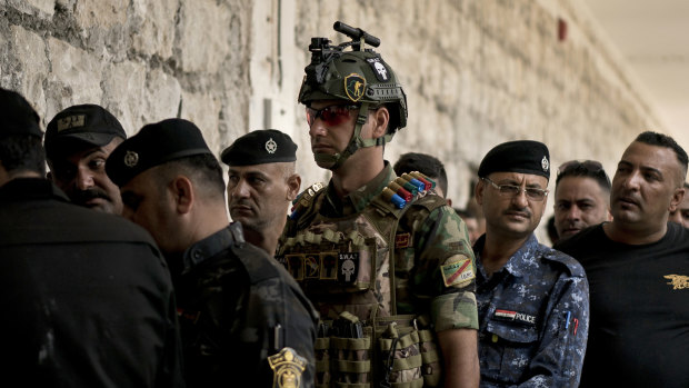 Soldiers wait to cast their ballots in early voting for Iraq's security forces, prisoners and hospital patients ahead of Saturday's national parliamentary elections.